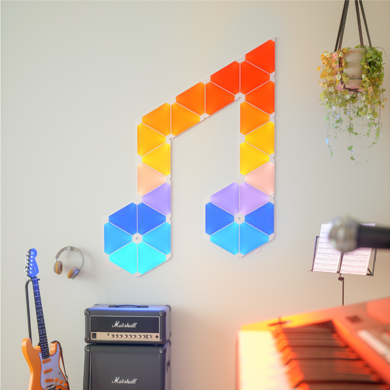 Nanoleaf Light Panels color changing triangle smart modular light panels mounted to a wall in a music room. Similar to Philips Hue, Lifx. HomeKit, Google Assistant, Amazon Alexa, IFTTT.